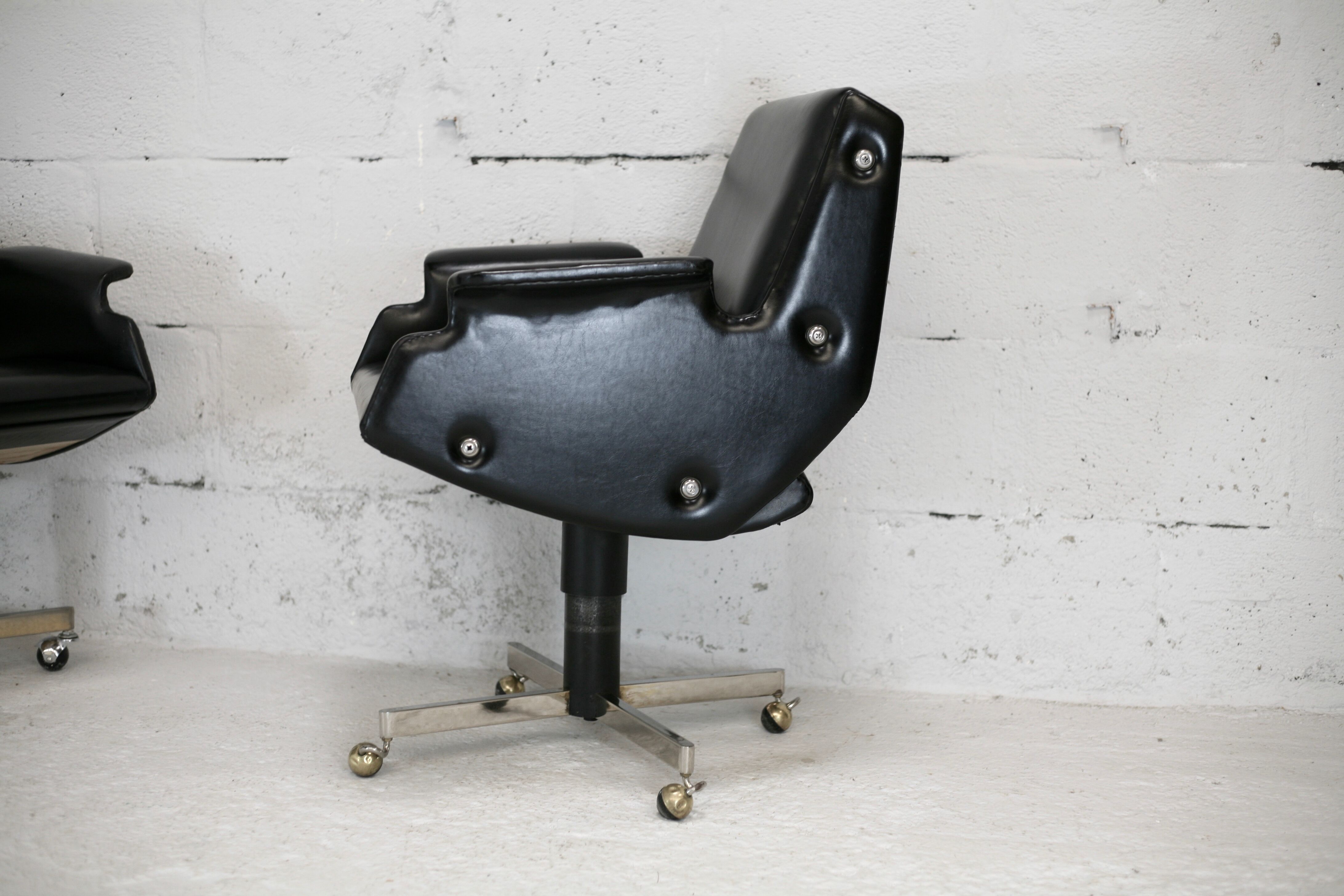 Pair of swivel armchairs, imitation leather and steel, Italy, circa 1960.