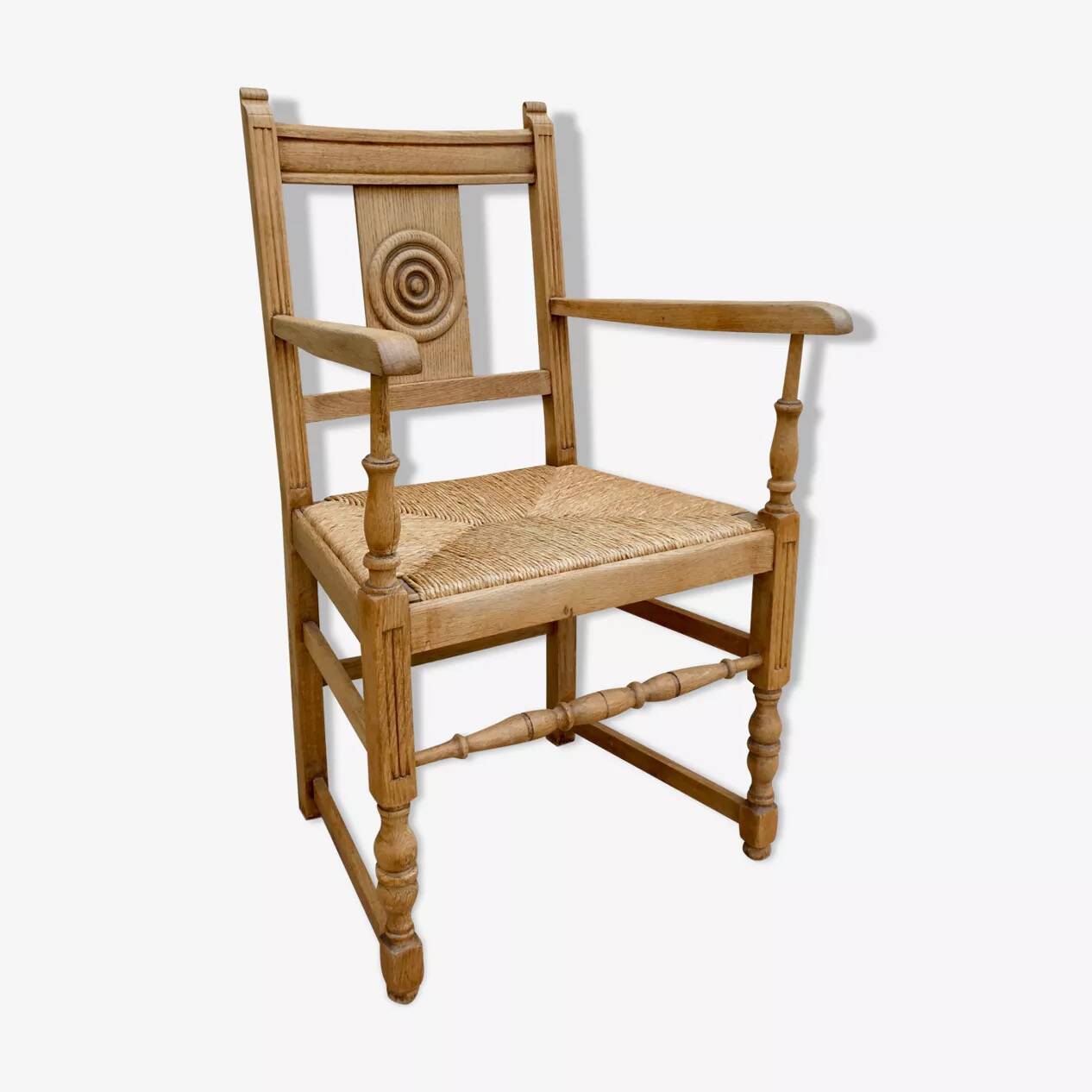 Light wood neo-Basque armchair with caned seat.