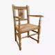 Fauteuil néo basque en bois clair et assise cannée