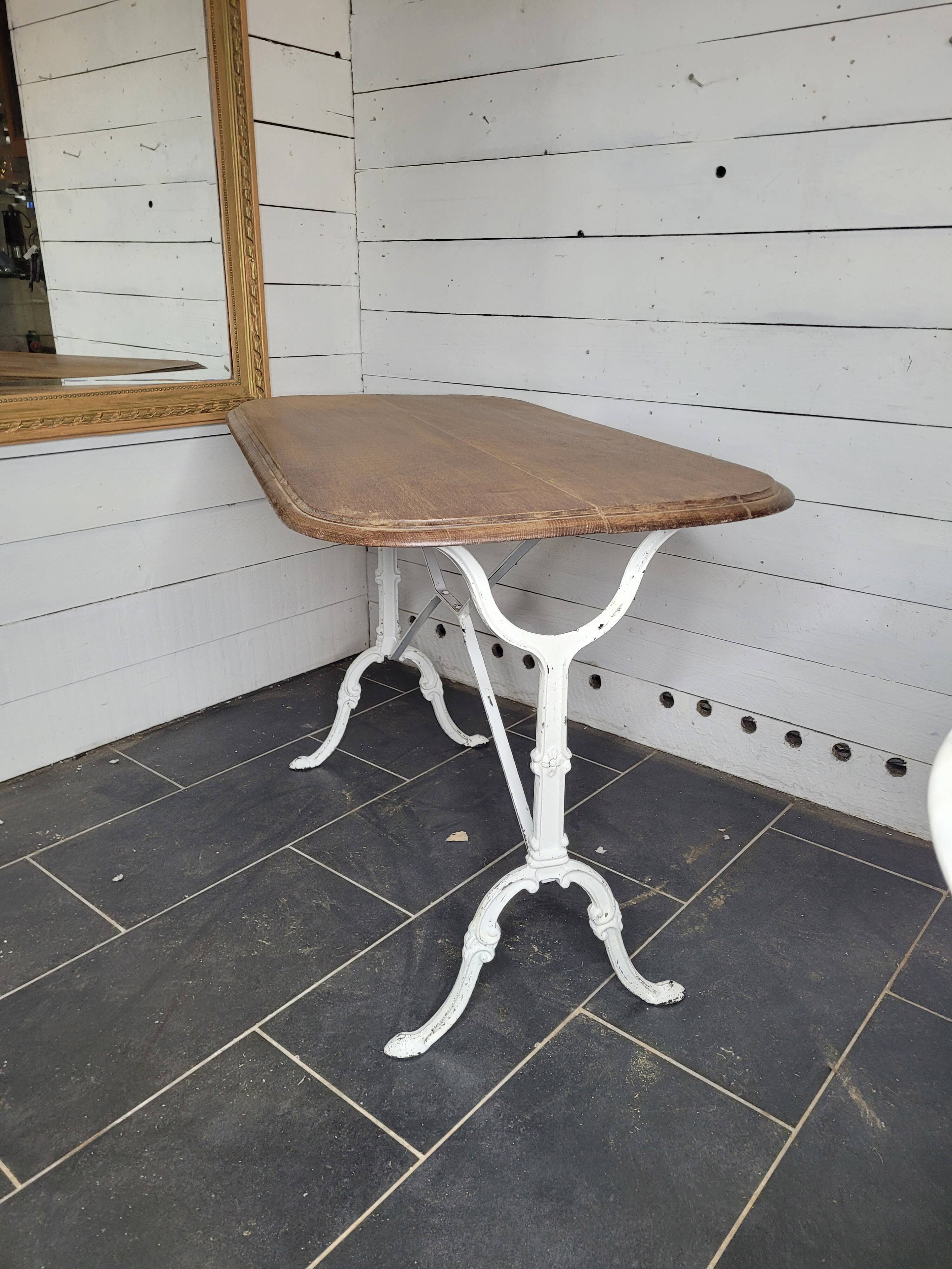 Bistro table with cast iron base and oak top