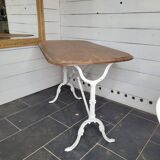 Bistro table with cast iron base and oak top