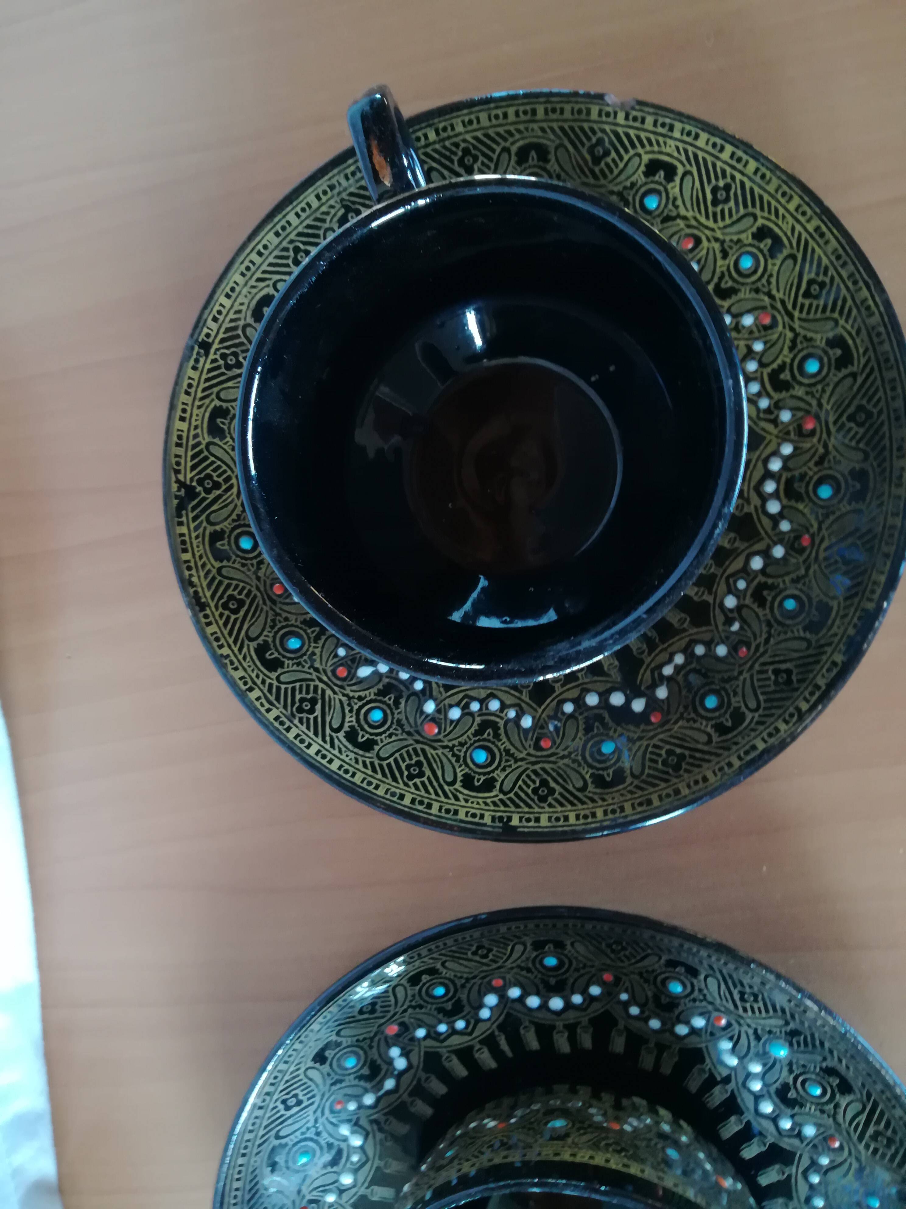 Black cups and saucers with relief decoration