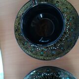 Black cups and saucers with relief decoration
