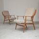 Pair of Boomerang-style armchairs in ecru beige fabric, 1960s.