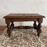 Low stool in carved wood