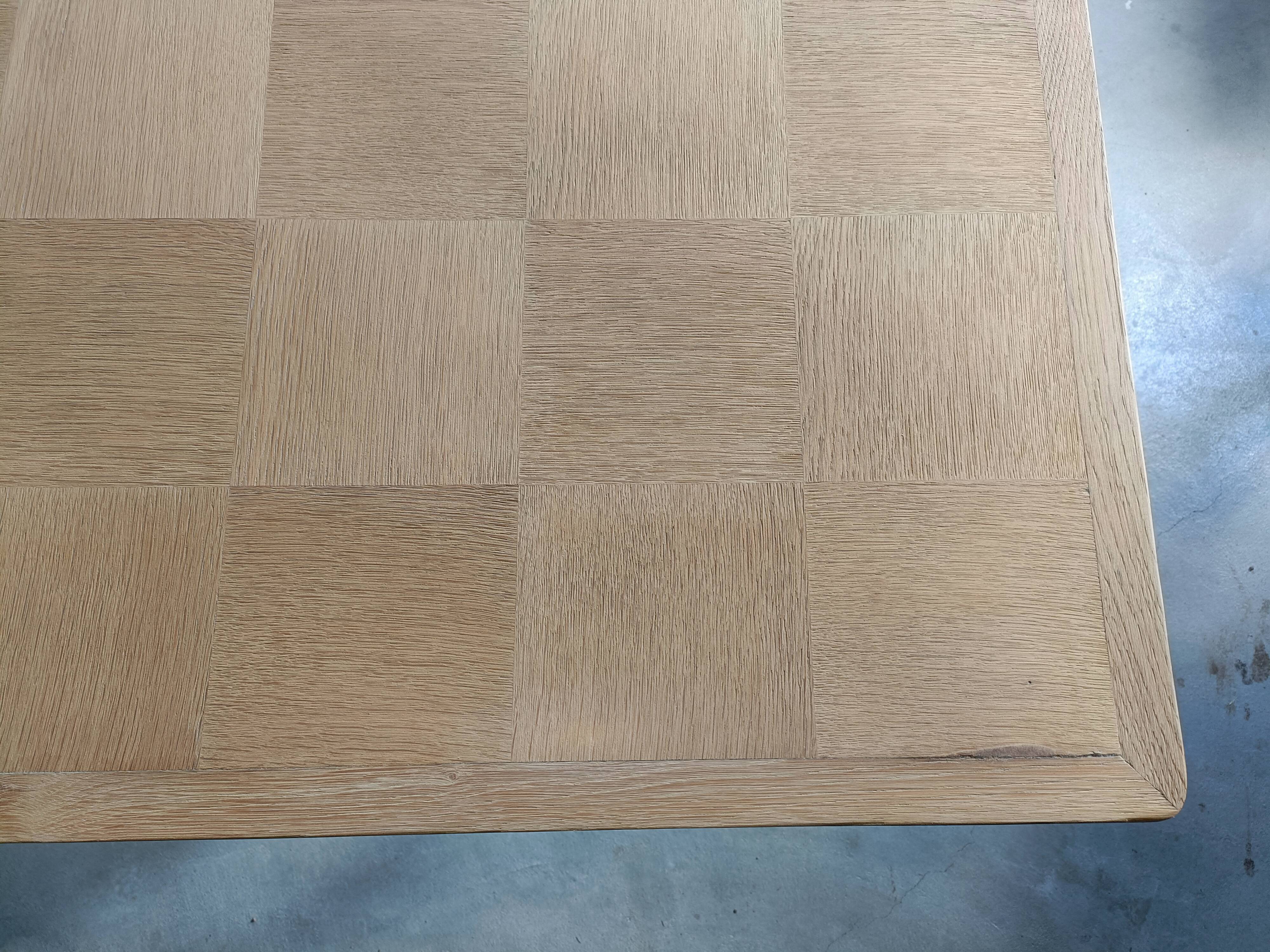 Oak dining table with a checkerboard top and extensions.