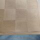 Oak dining table with a checkerboard top and extensions.