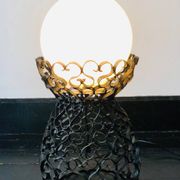 Black wrought iron lamp with a white glass globe.