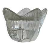 Glass candle holder in the shape of a tulip.