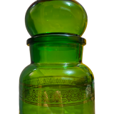 Green apothecary jar with golden patterns