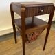 Art Deco sewing table in walnut with a foldable shelf.