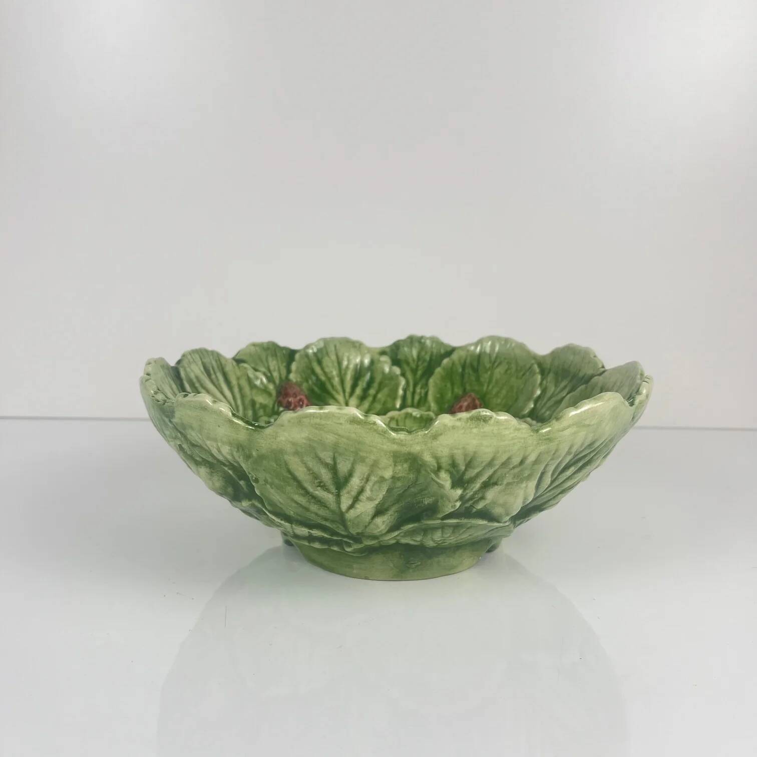 Leaf and strawberry-shaped bowl/strainer.