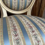Pair of Louis XVI style chairs in painted wood and satin, classic elegance.