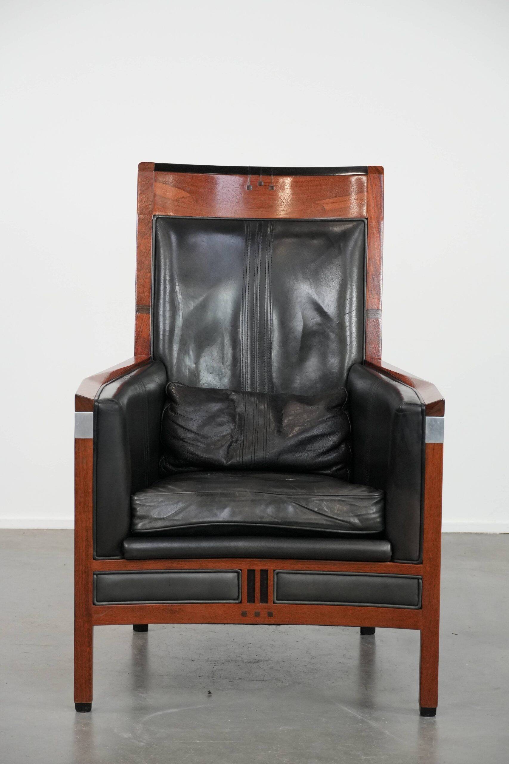 Black cowhide leather and wooden Art Deco design armchair