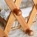 Antique wall-mounted coat rack accordion in dark pine, 10 wooden hooks.