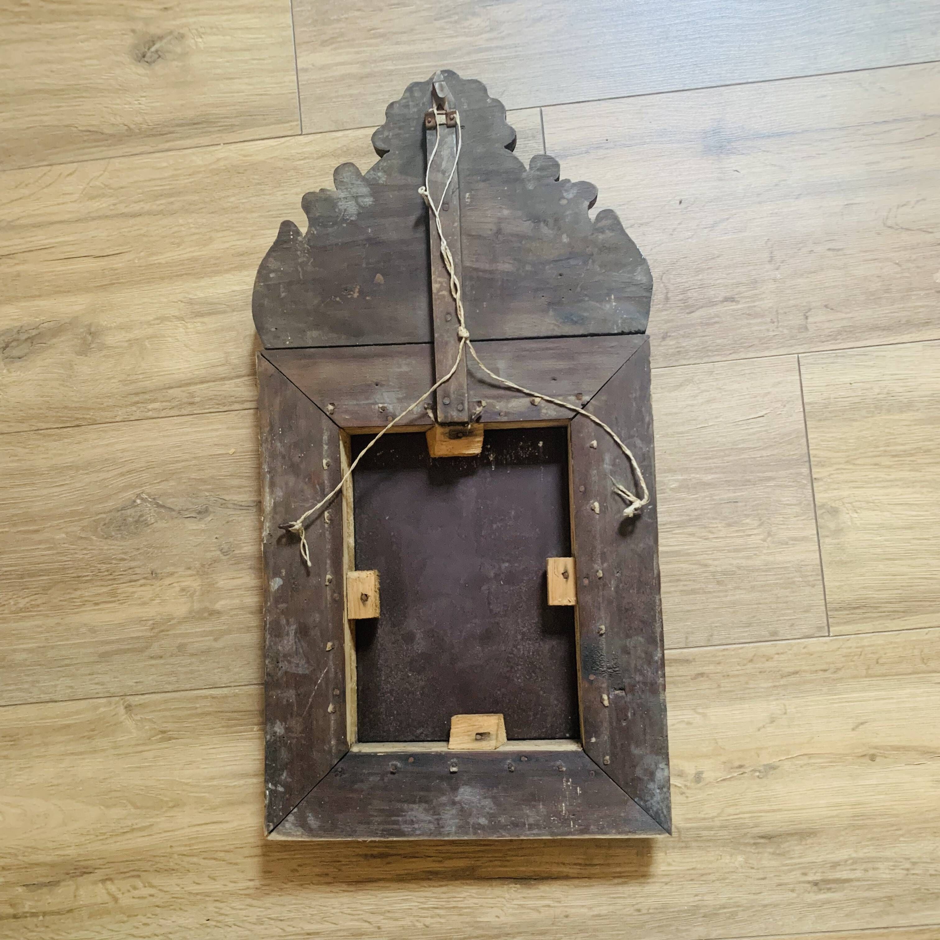 Small mirror with repoussé brass frame.