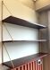 Scandinavian wall-mounted bookcase with floating rosewood shelves, period