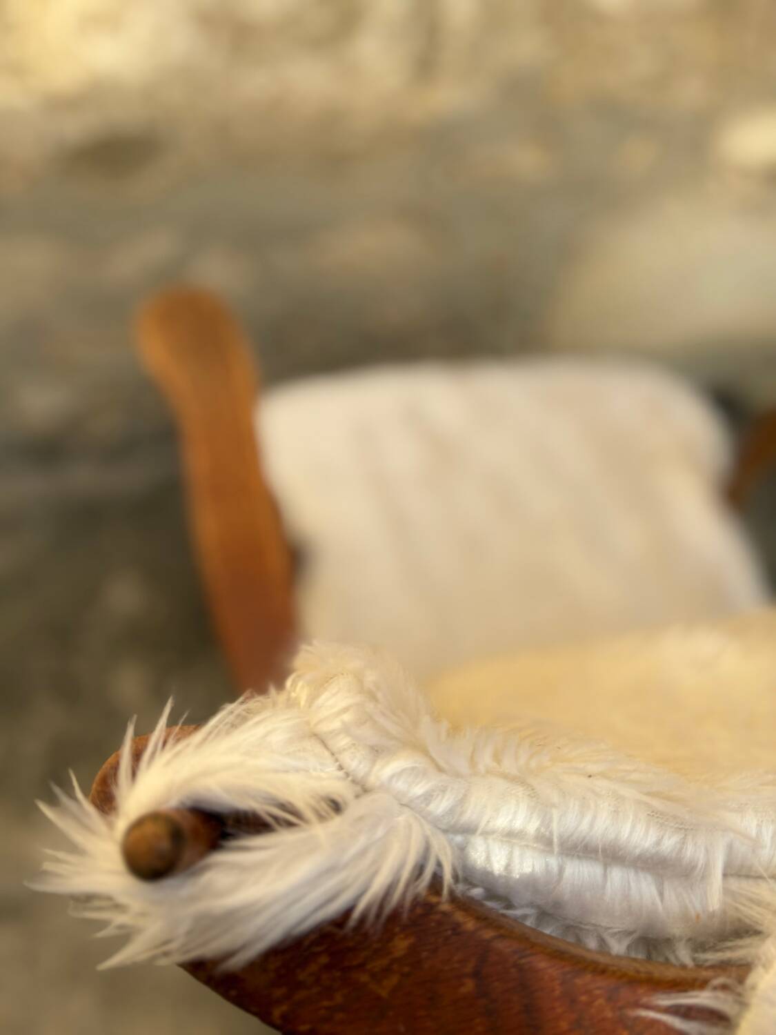 Scandinavian armchair in solid wood with beige fur cushion