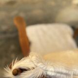 Scandinavian armchair in solid wood with beige fur cushion