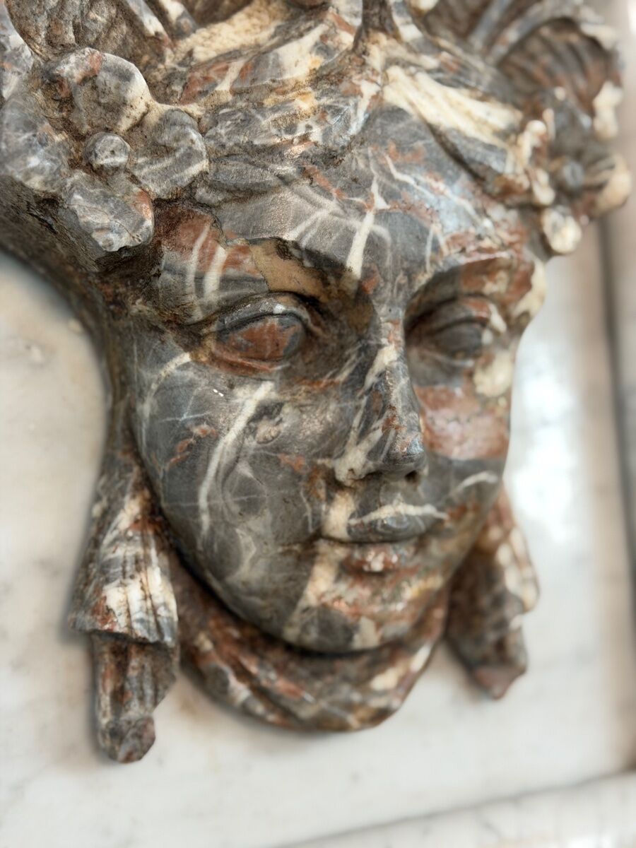 Female mascaron in grey Ardennes marble from the Regency period, 18th century.