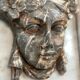 Female mascaron in grey Ardennes marble from the Regency period, 18th century.