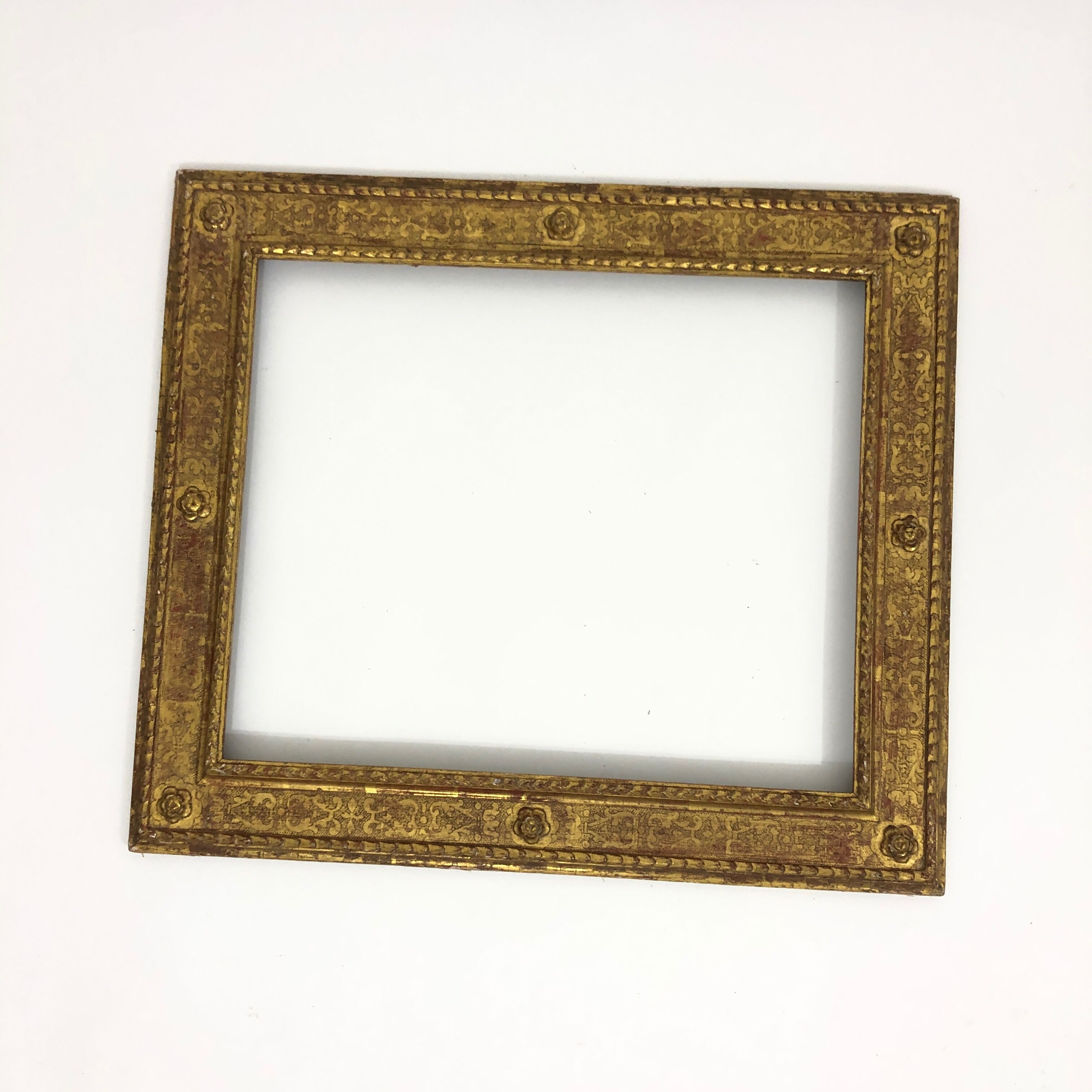 Vintage gilded frame decorated with stylized flowers