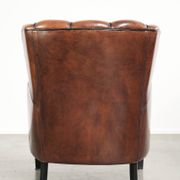 Unique sheepskin armchair with warm deep colours finished with black piping