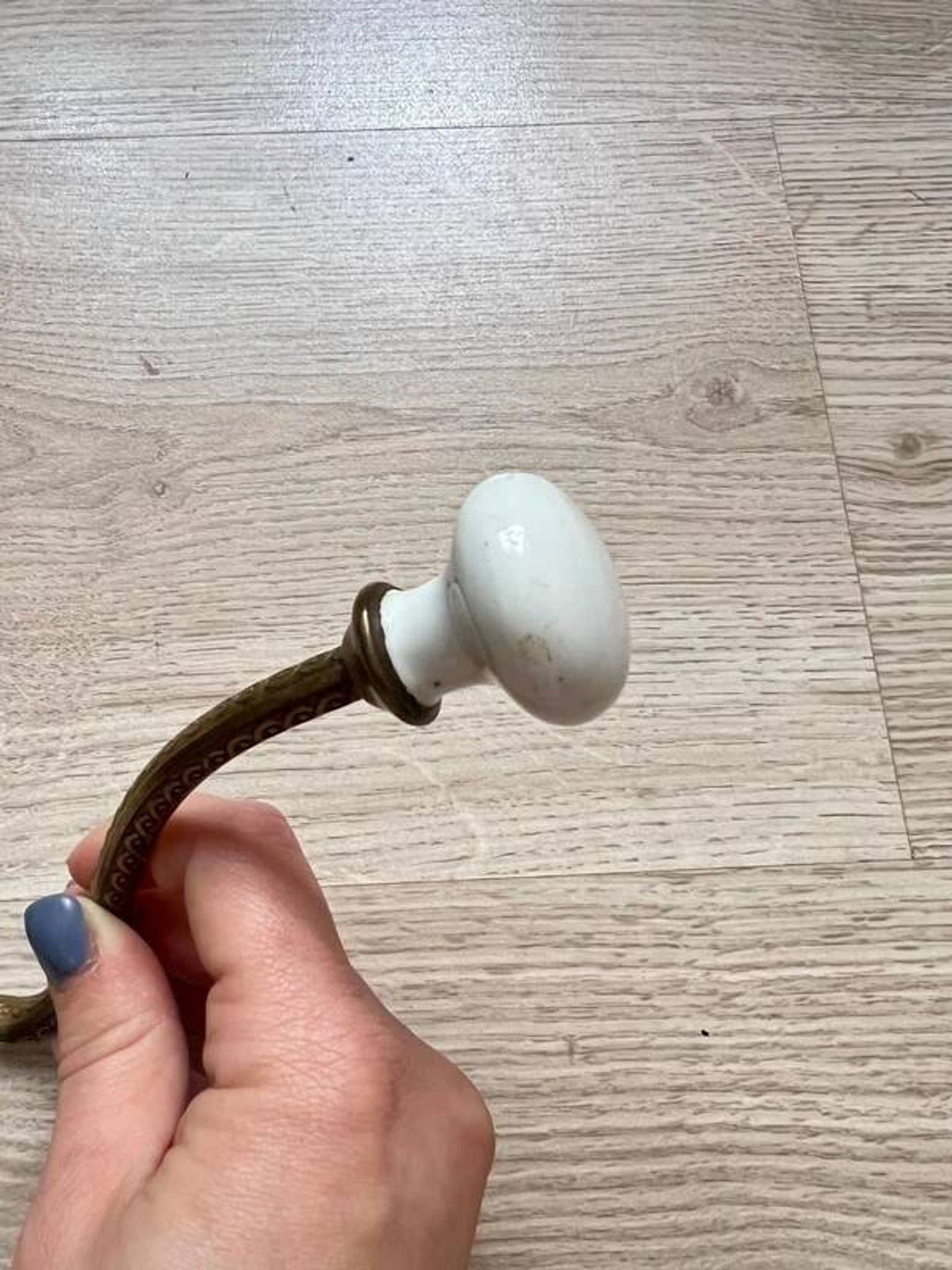 Vintage brass coat hook with ivory-style knob
