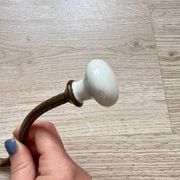 Vintage brass coat hook with ivory-style knob