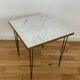 End table in gold metal, white marble top. 60s