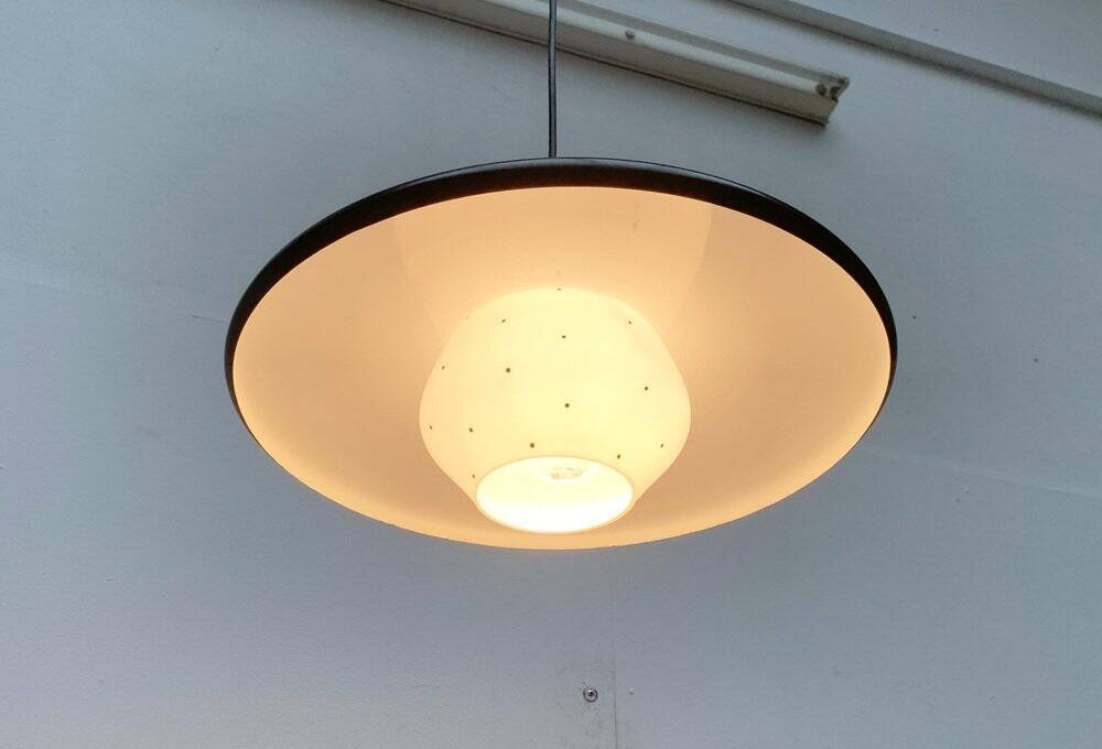 Minimalist metal and glass pendant lamp in mid-century style.