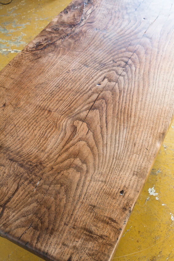 Old coffee table in solid oak wood. France, early twentieth century.