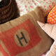 Jute Canvas cushion Red flag Majuscule H in coat of the house