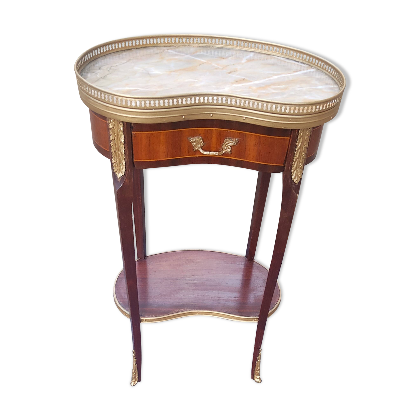 Louis XVI period pedestal table, in solid mahogany and veneer, and in gilded bronze.