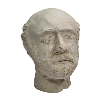 Man's head modeled in white clay