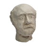 Man's head modeled in white clay