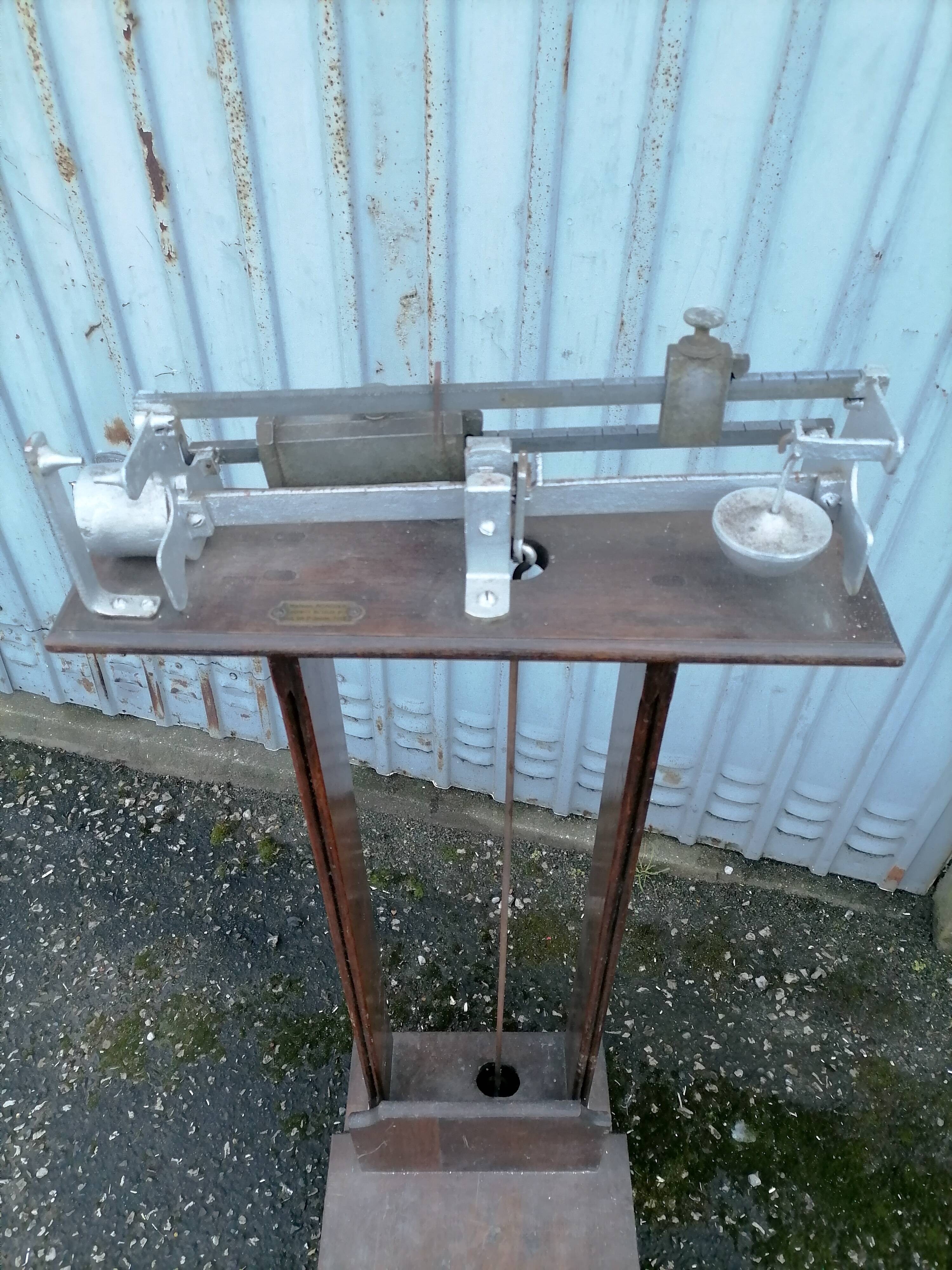 Old scale at pharmacy wood house rongier weighs person