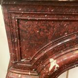 Pair of Louis XIV style fireplaces in red cherry marble. XIX century.