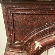 Pair of Louis XIV style fireplaces in red cherry marble. XIX century.