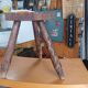 Vintage tripod stool in carved solid wood.
