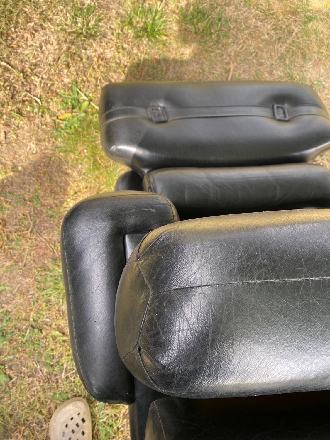 Pair of black imitation leather armchairs