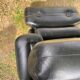 Pair of black imitation leather armchairs