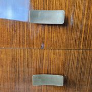 Mid-century drawer chest in mahogany, brass and glass.