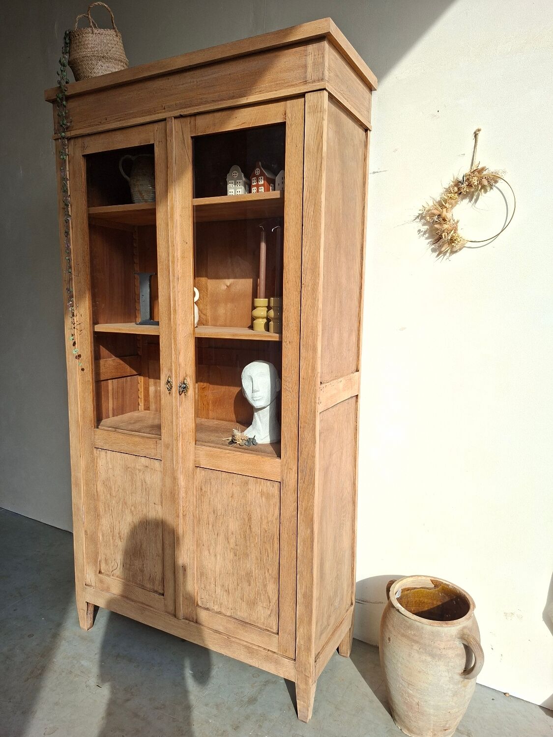 Large antique display cabinet in patinated solid oak.
