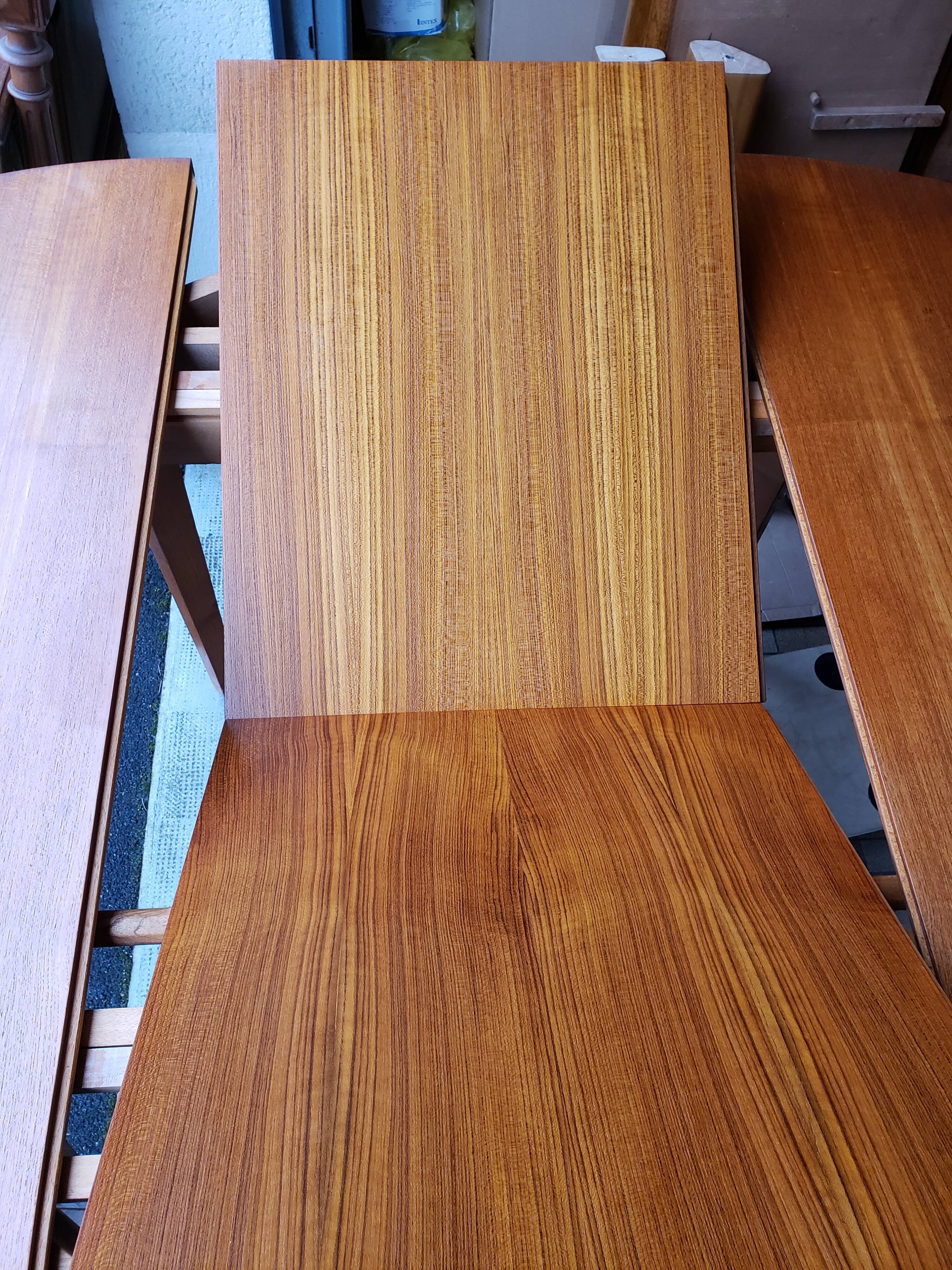 Round extendable teak dining table from the 60s