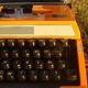 Silver reed orange and black typewriter with bag