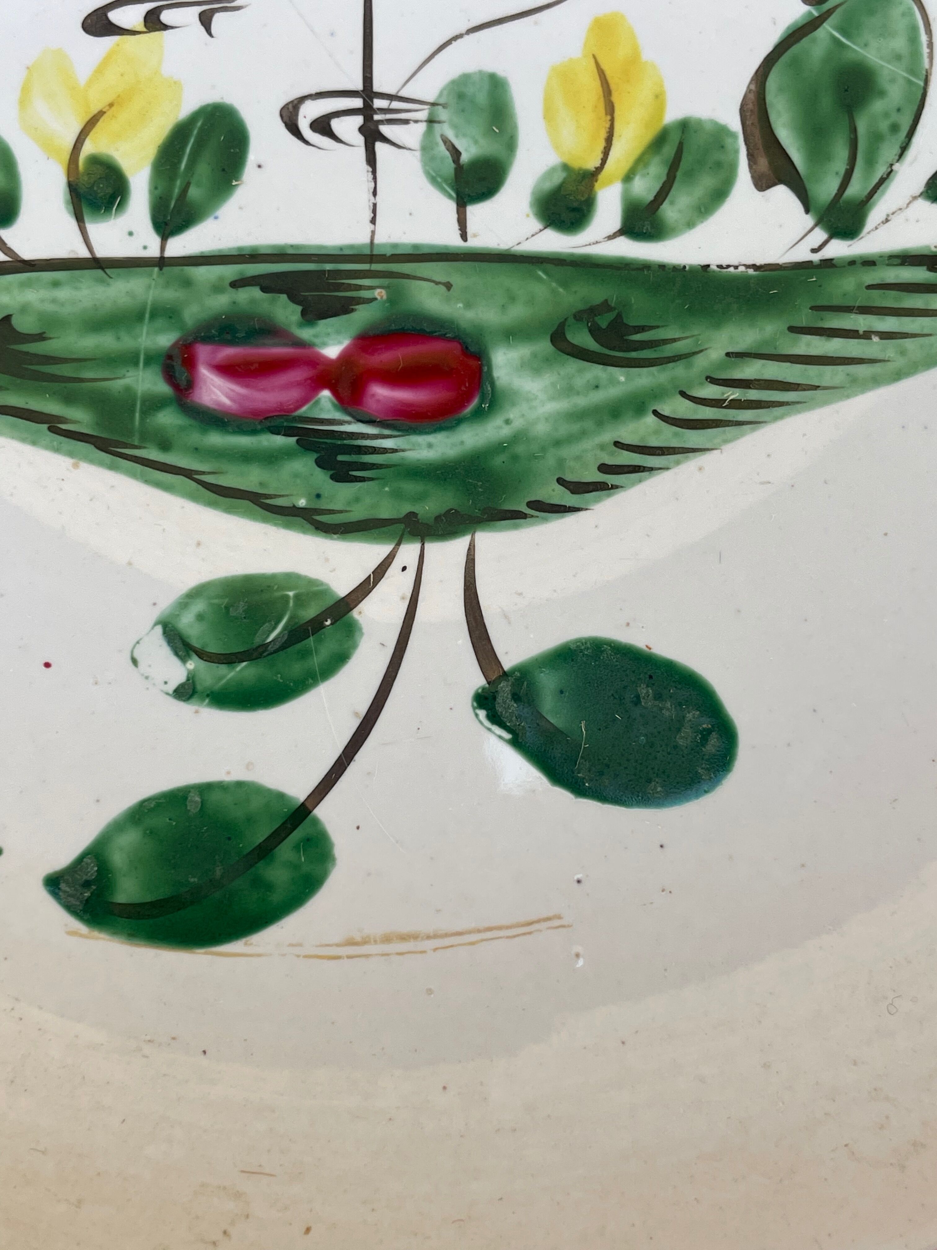 Antique plate with a flower and rooster pattern.