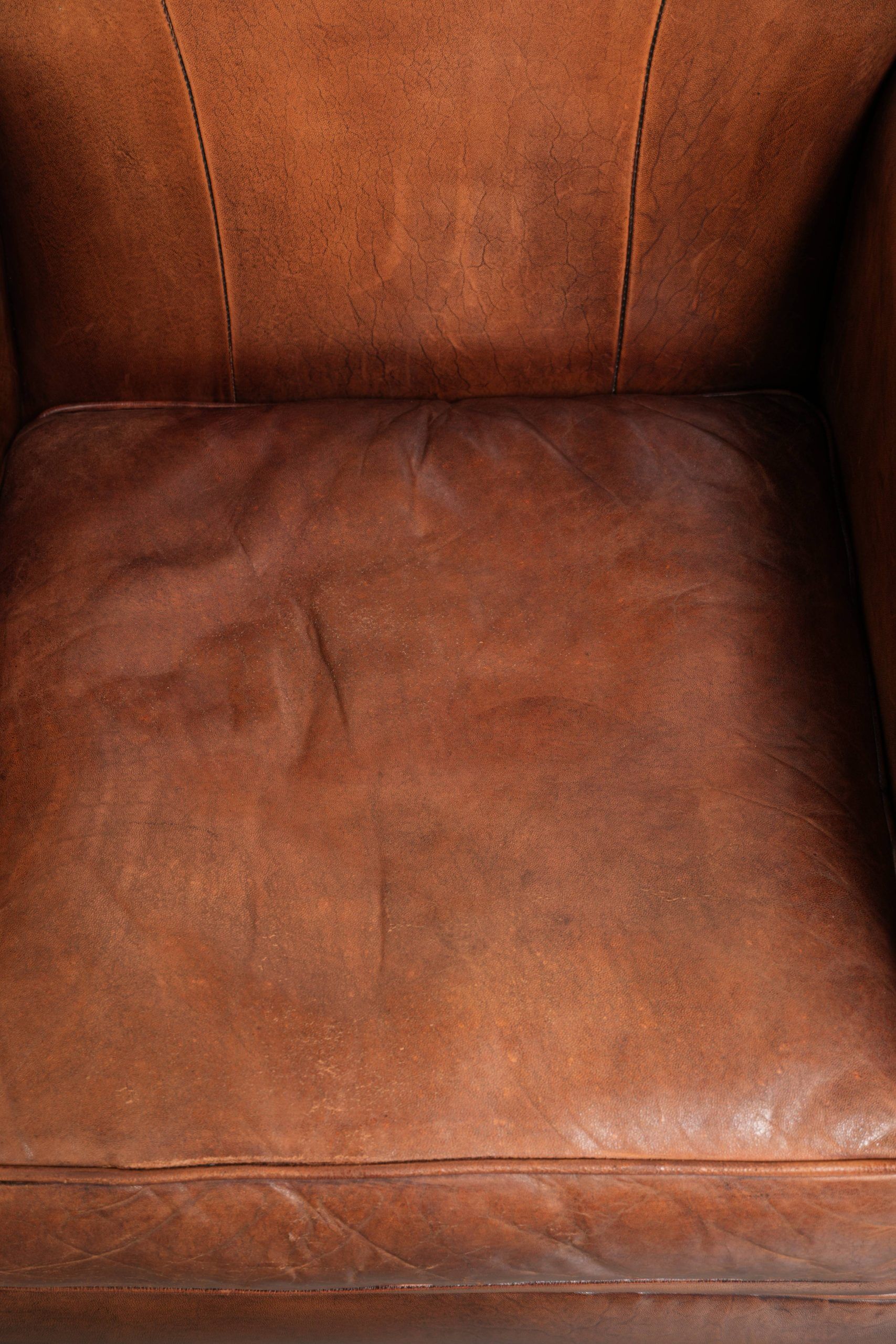 Sheepskin armchair with comfortable seat and finished with decorative nails