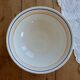 Vintage porcelain salad bowl with multicoloured borders.