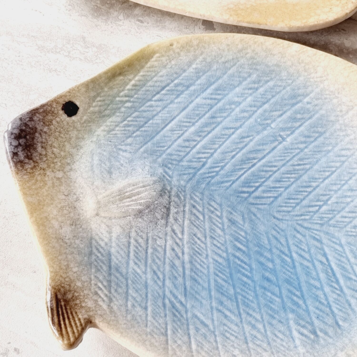 2 empty ceramic fish pockets